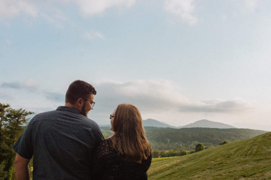 Couple looking at the blue ridge mountains during their engagement session